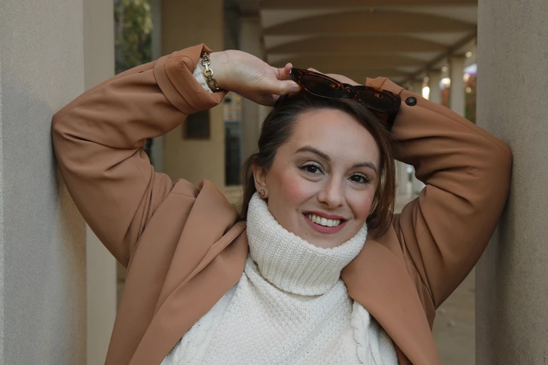 Sarah Milko, life coach and psychic medium, smiling warmly in a portrait photograph