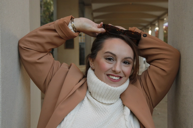 Sarah Milko, life coach and psychic medium, smiling warmly in a portrait photograph